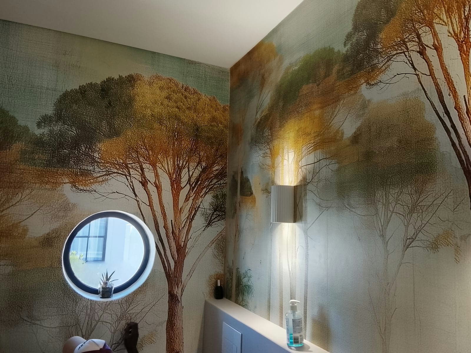 Completed forest mural around a feature window