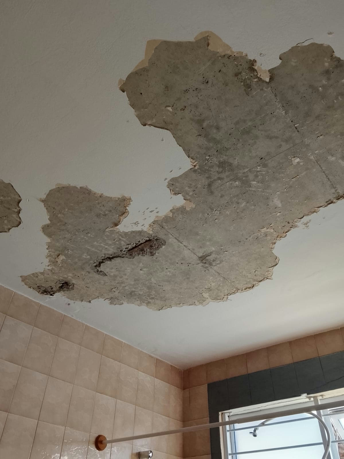 Damaged bathroom ceiling stripped for repair