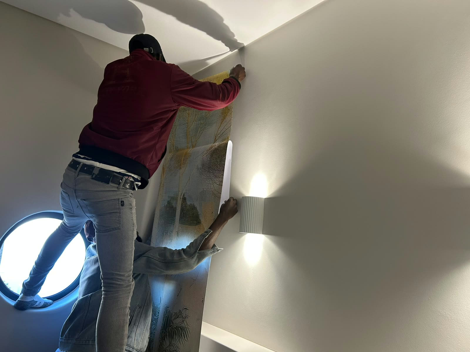 Team installing a large scenic wall mural
