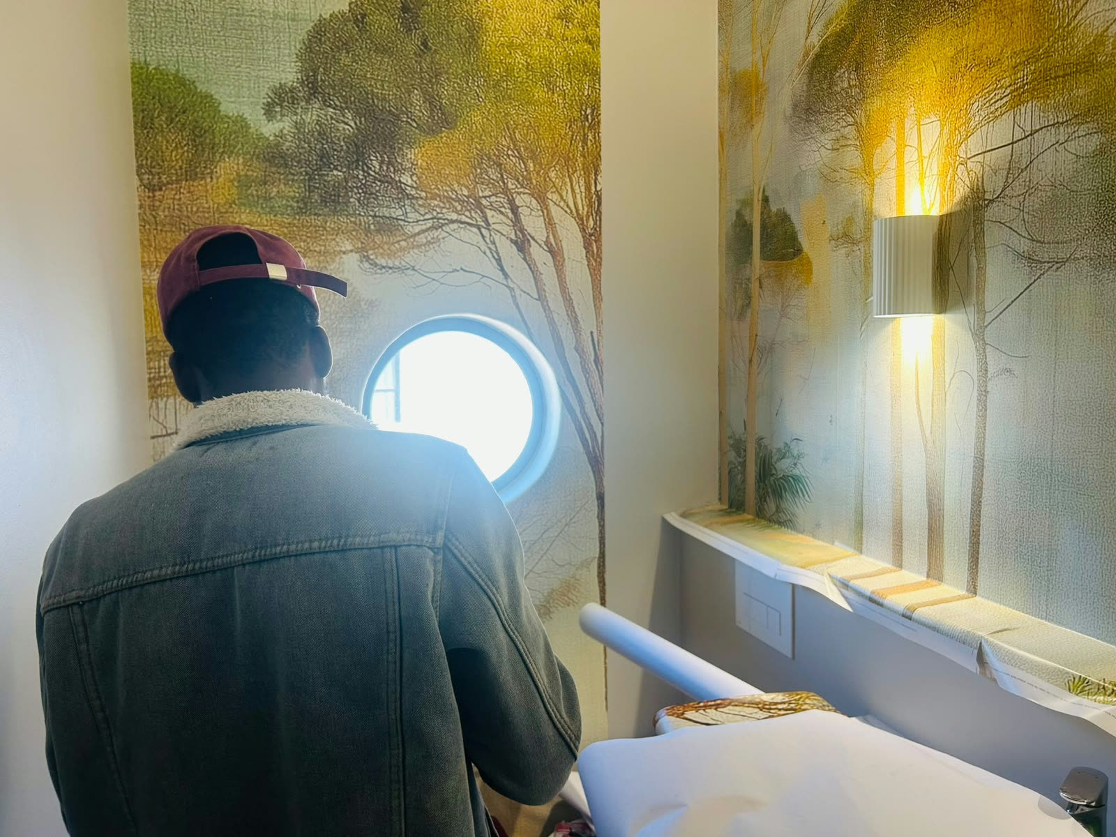 Mural wallpaper installation in a bathroom